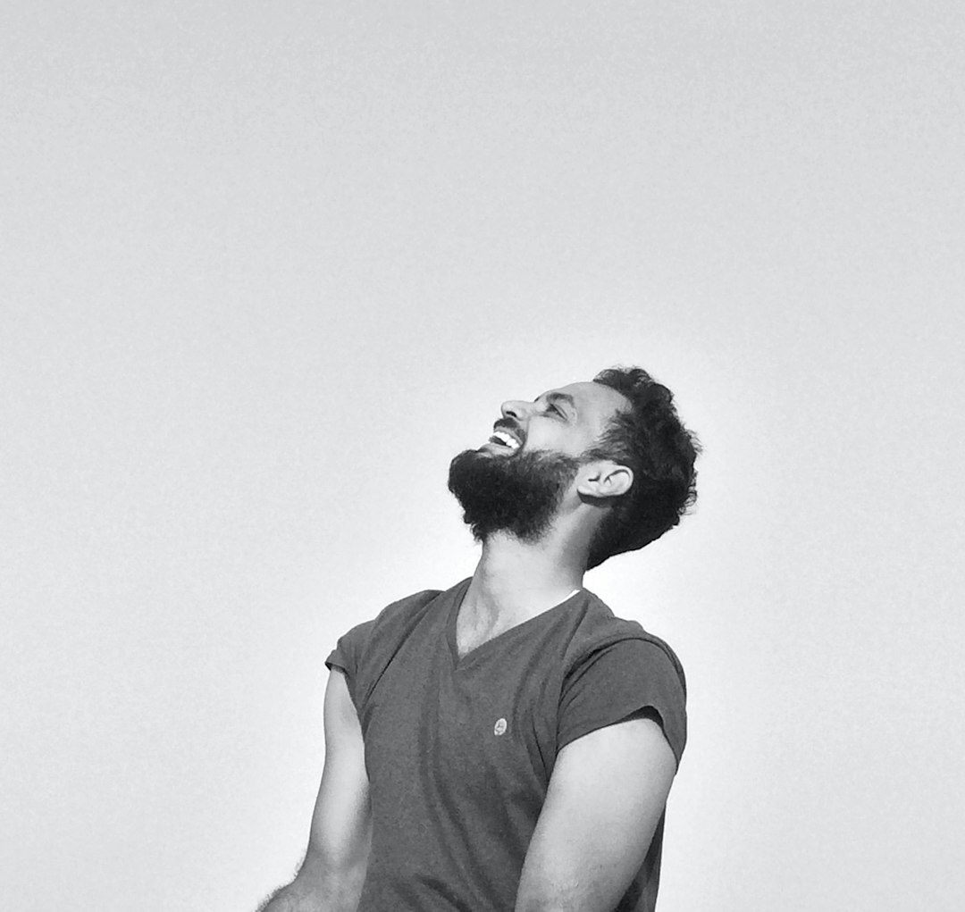 Latino man with a beard smiling in casual professional attire
