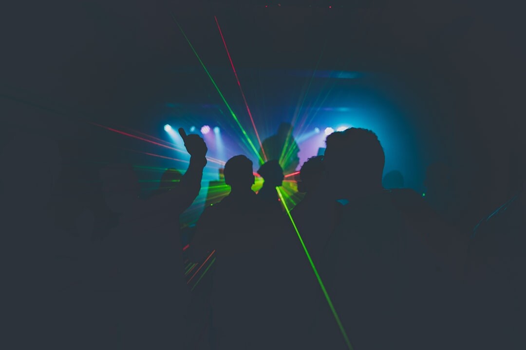 Crowd dancing at a colorful nightclub with neon lights