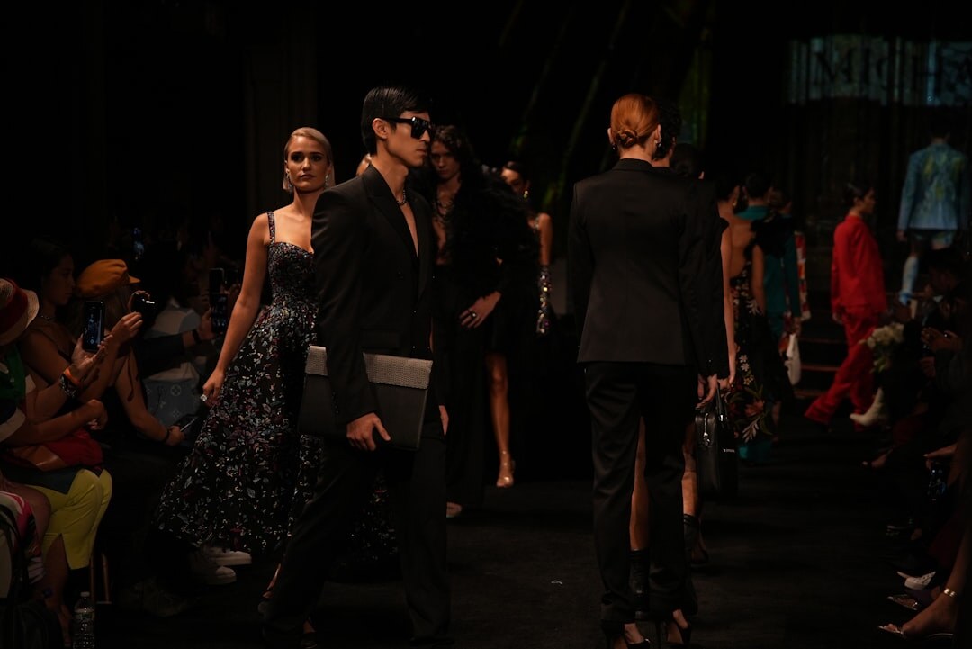 Model walking on a fashion runway under bright lights