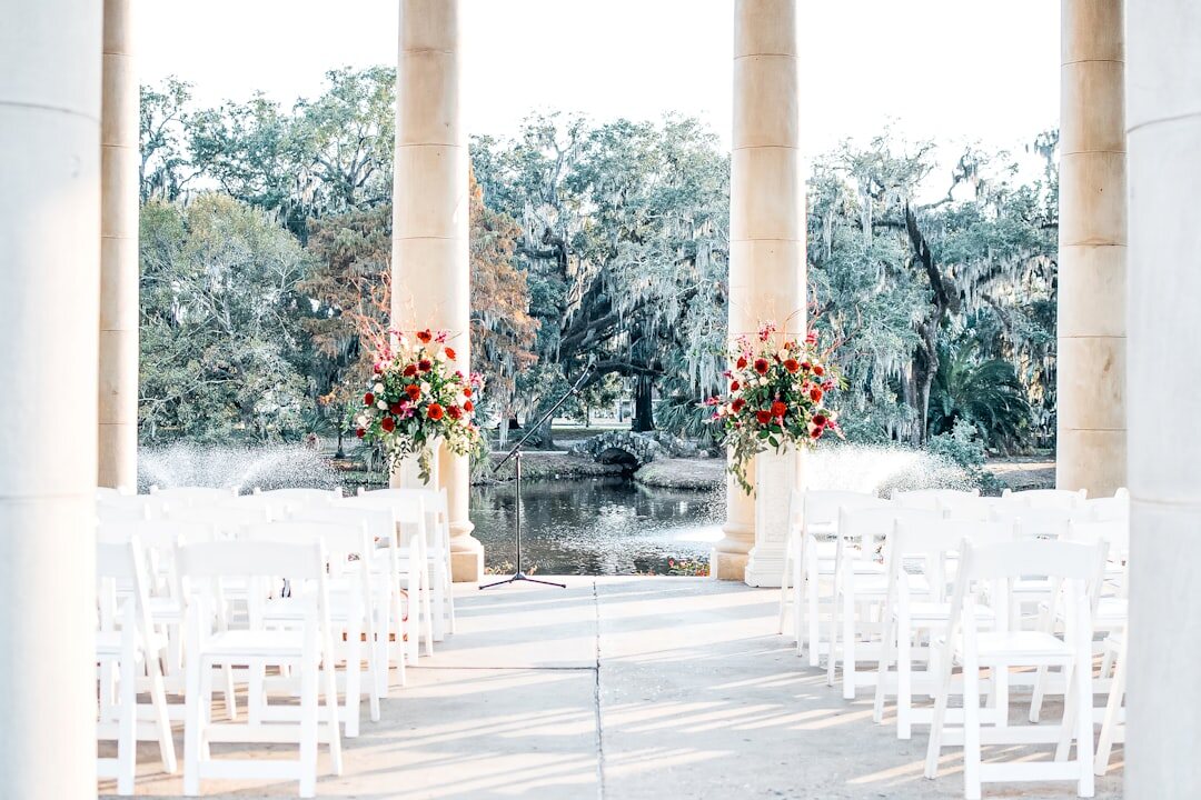 Elegant outdoor wedding ceremony decorated with flowers and lights
