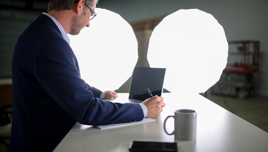 Journalist working with notes and a laptop at a desk